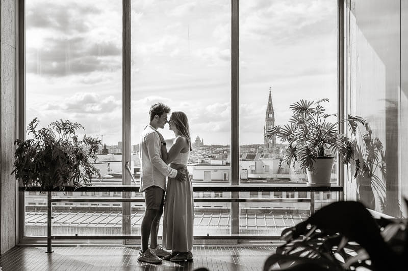 Couple hugging with Brussels skyline in the background