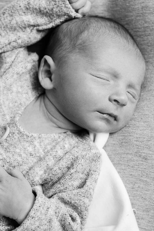 black and white photo of sleeping newborn baby